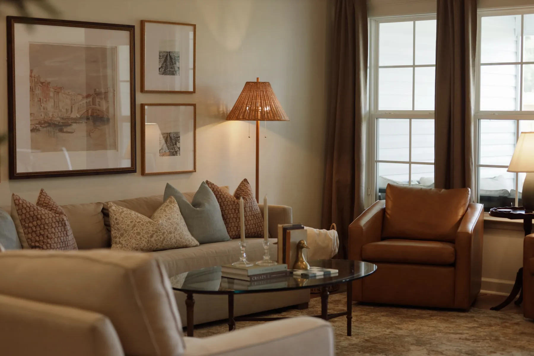 Living room with a framed art wall and pillowed sofa — residential interior design in Valdosta, GA